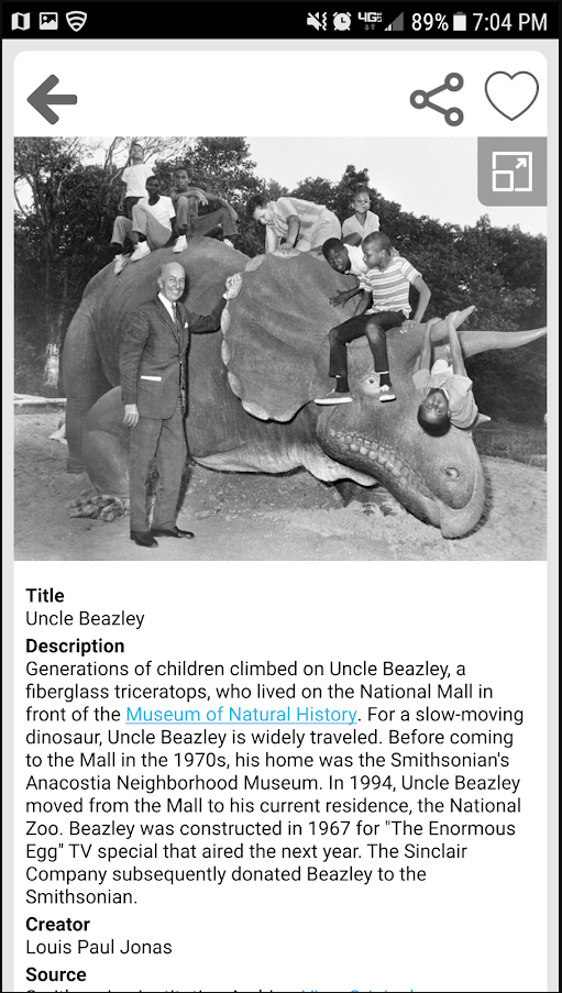 Mockup of how a single item displays on the mobile app. There is an older white man leaning against a large fiberglass triceratops. Seven children sit on the triceratops. Below the image is a display of Dublin Core metadata for the image.