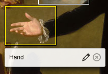 The same image of a hand with palm upturned as before. This time the highlight of the rectangle surrounding the hand is yellow, not white, and the area below it has a caption "hand" to the left of a pencil icon for edit and an x in a circle icon for delete