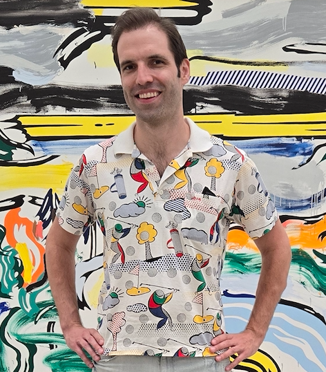 Head shot of dark haired man in colorful collared shirt