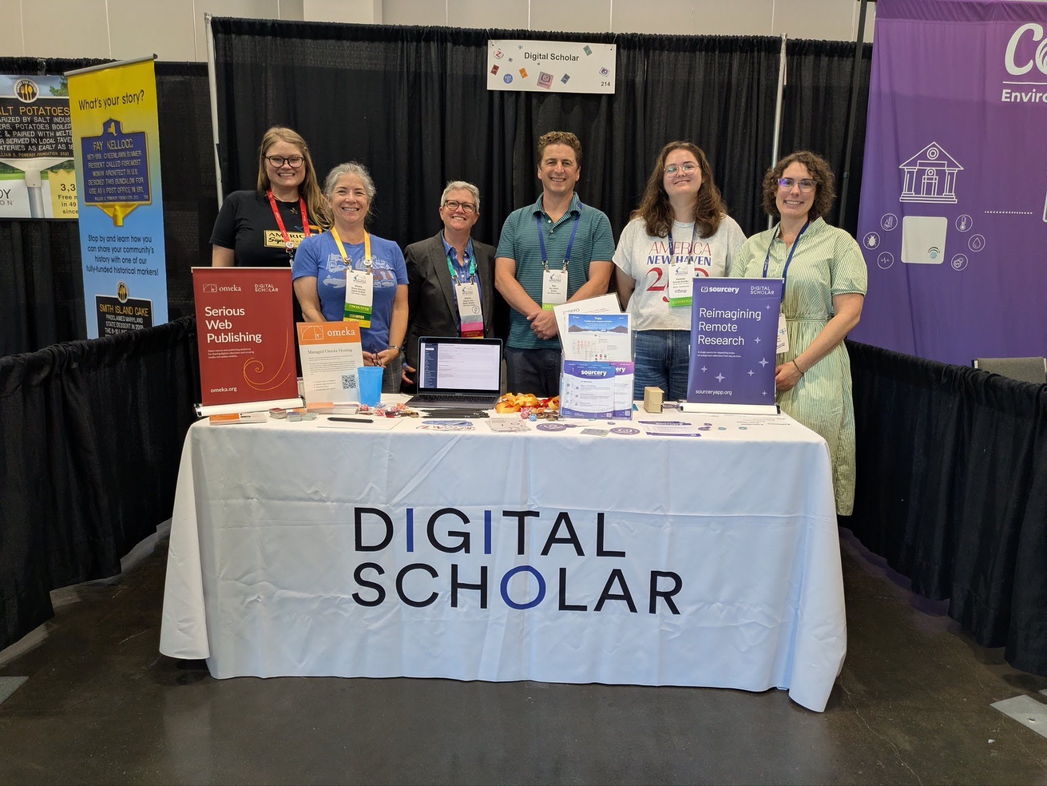Six members of the Digital Scholar team at their booth at NCPH 2026