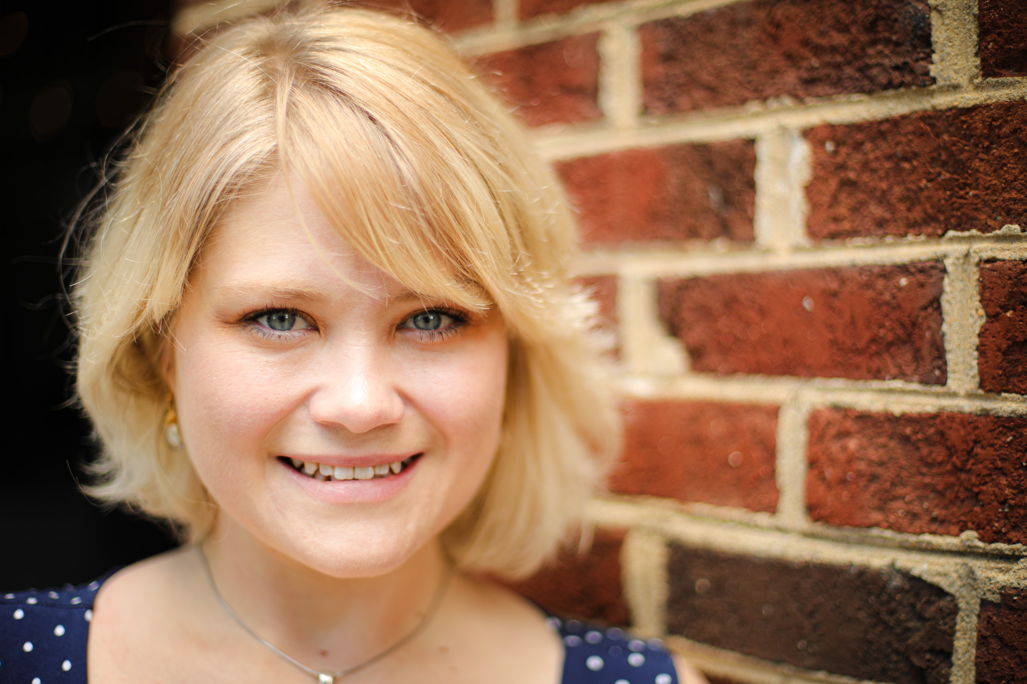 Head shot of woman with blonde hair in a dress shirt